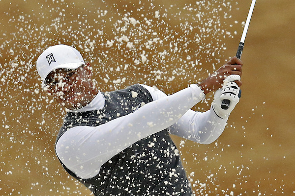 Tigers Woods hits out of the sand trap on the fourth hole during the second round of the Phoenix Open golf tournament,